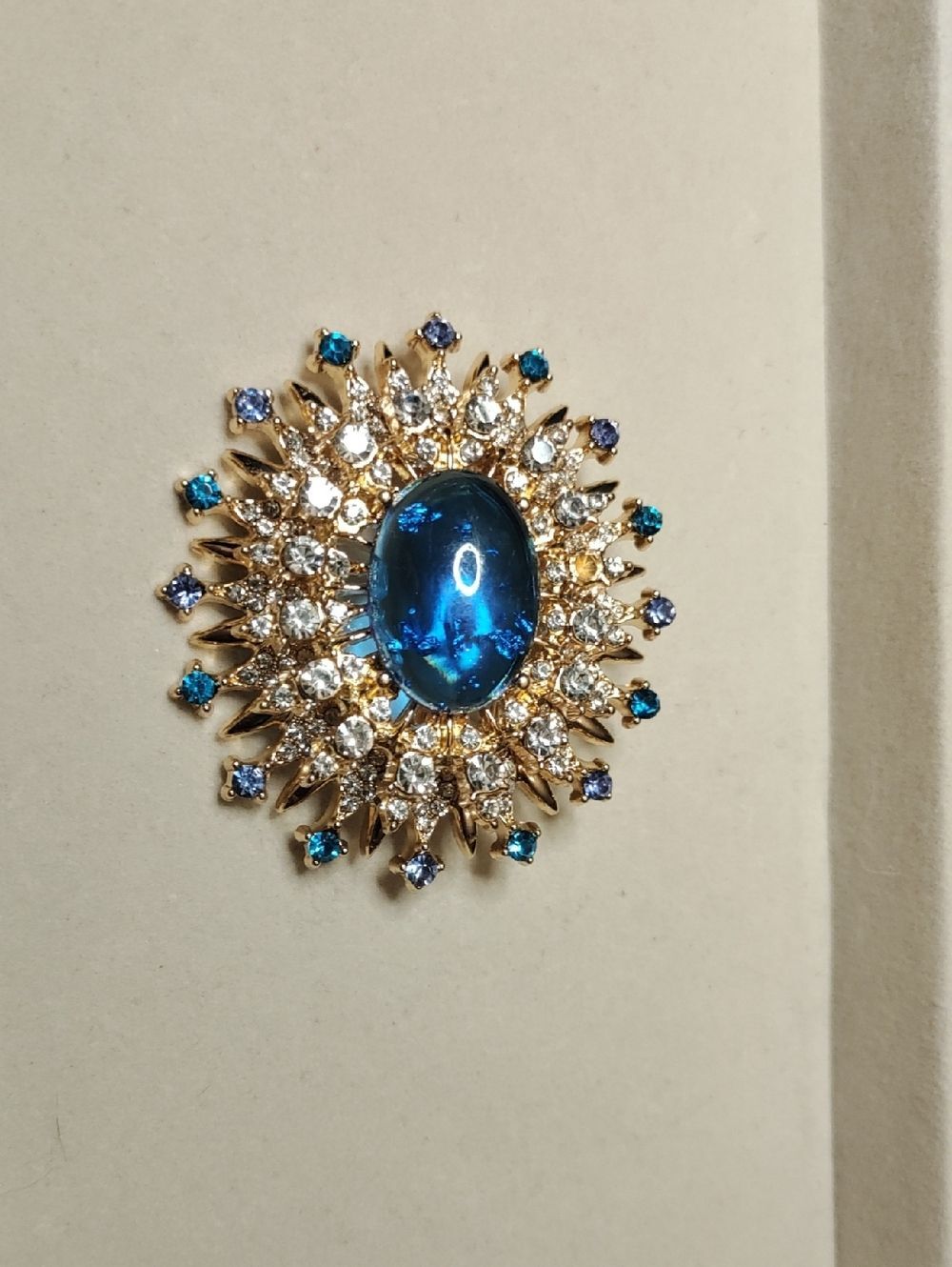 Elegant Gold-Tone Blue Crystal Sunburst Brooch